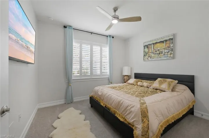 Bedroom with carpet flooring and a ceiling fan