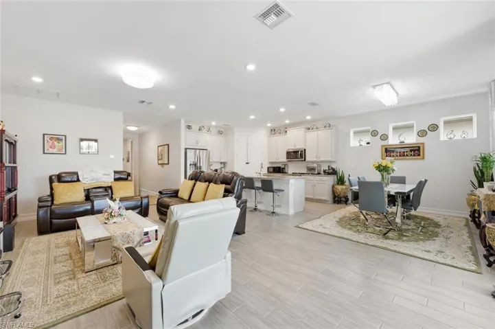 Living area featuring wood finish floors and recessed lighting