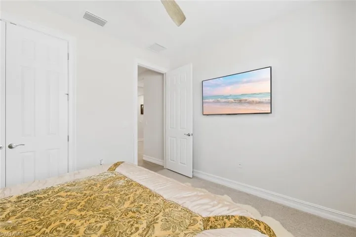 Unfurnished bedroom with carpet and ceiling fan