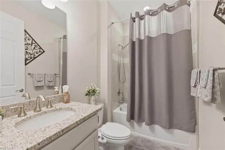 Full bath with vanity and shower / bath combo