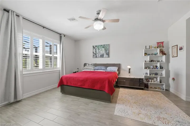 Bedroom with light wood-style flooring and a ceiling fan