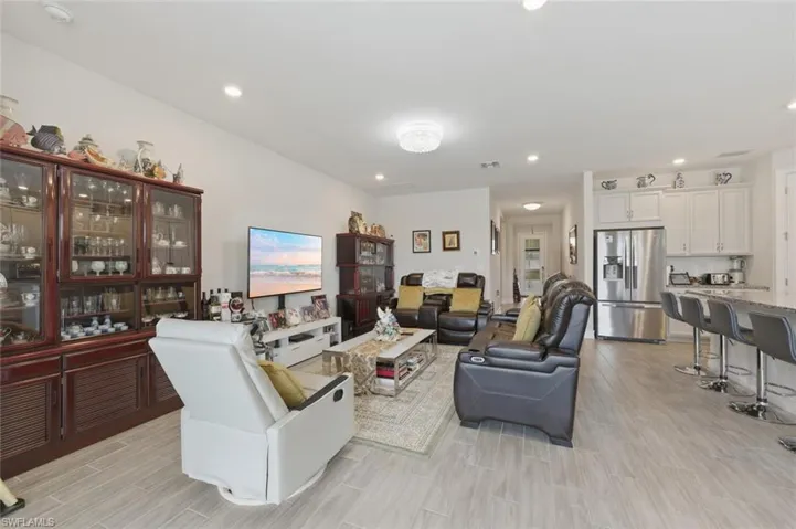 Living room featuring wood tiled floors and recessed lighting