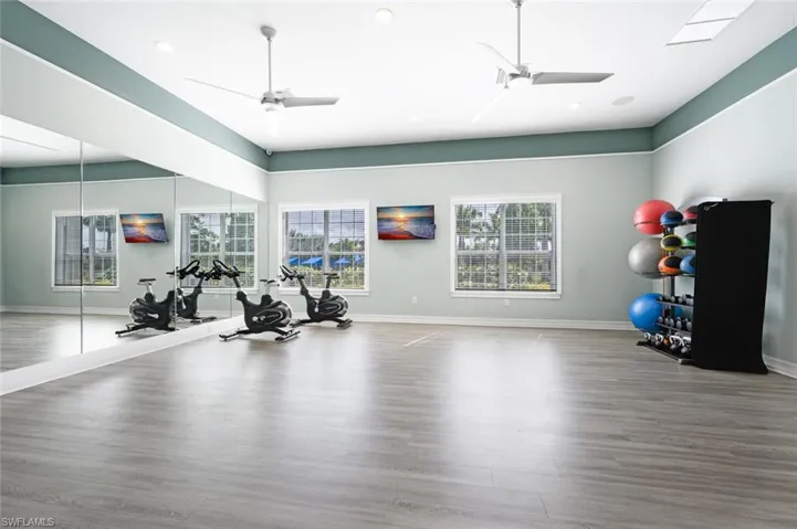 Workout room featuring ceiling fan and recessed lighting