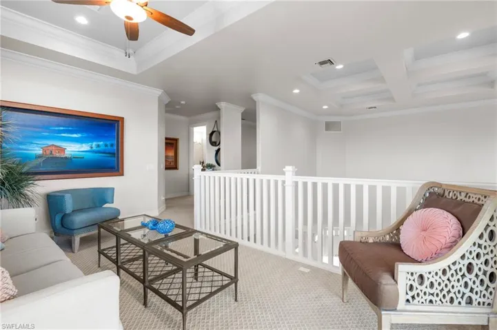 Carpeted living area featuring recessed lighting, crown molding, ceiling fan, coffered ceiling, and beamed ceiling