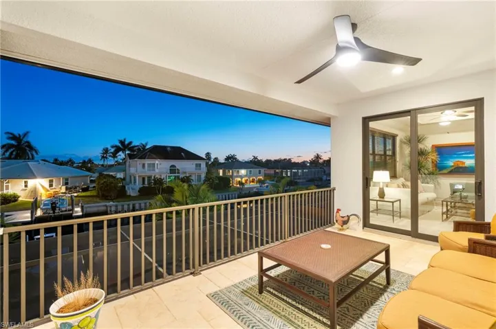 Balcony with a residential view, ceiling fan, and outdoor lounge area