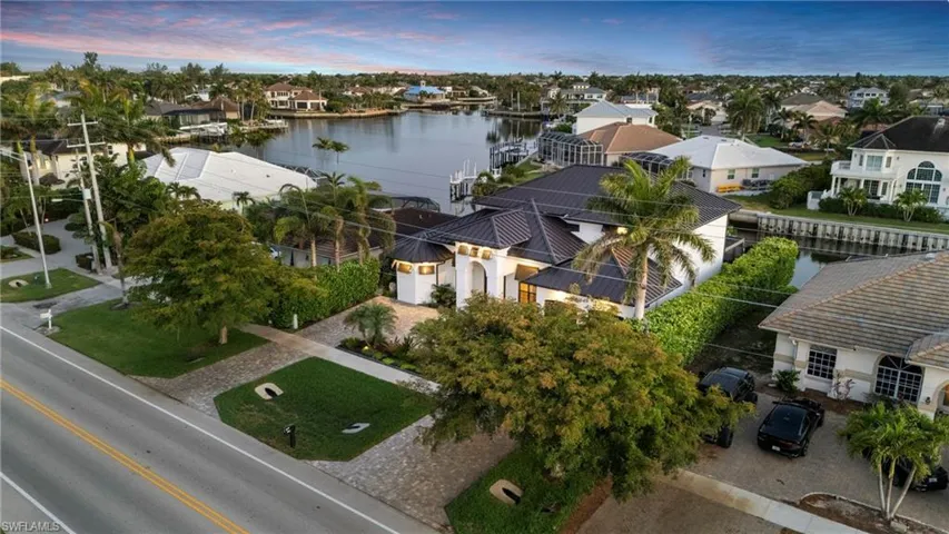 Aerial perspective of suburban area featuring a nearby body of water