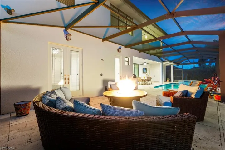 View of patio / terrace featuring an outdoor hangout area, french doors, an outdoor pool, glass enclosure, and ceiling fan