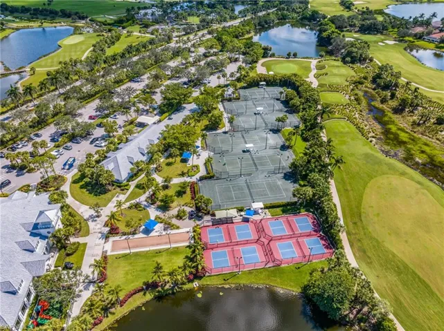 Aerial view of property and surrounding area with a large body of water and a local golf course