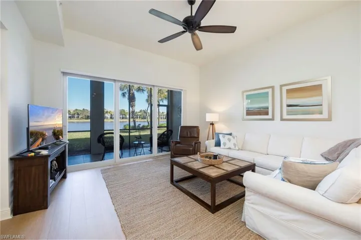 Living room with light wood-style flooring and a ceiling fan