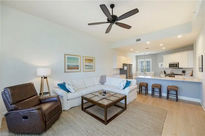 Living area featuring light wood-style flooring, recessed lighting, and a ceiling fan