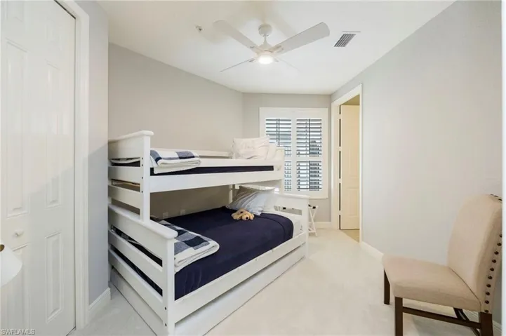 Bedroom featuring light carpet and ceiling fan