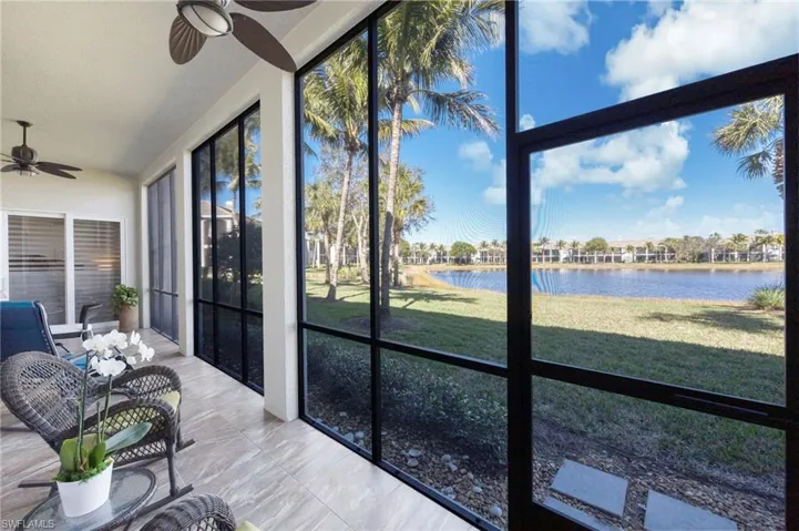 Lanai with a ceiling fan, a water view, and french doors