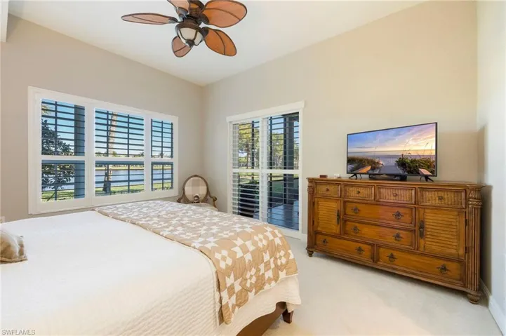 Bedroom featuring light colored carpet and ceiling fan