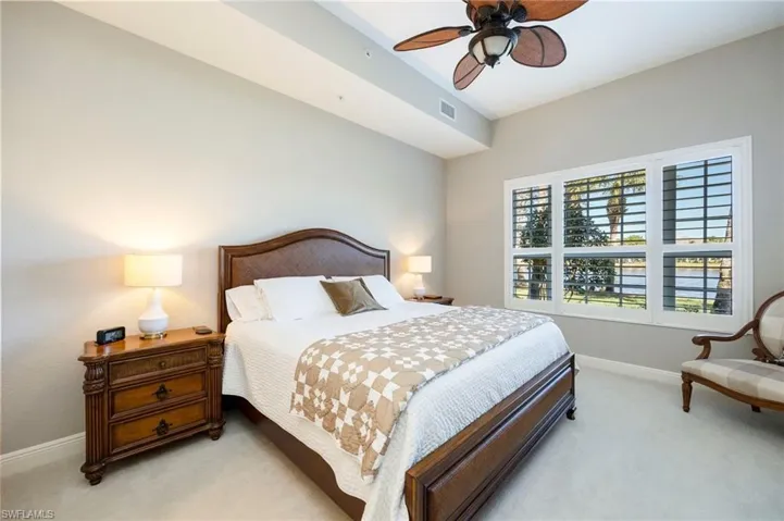 Bedroom featuring ceiling fan and carpet
