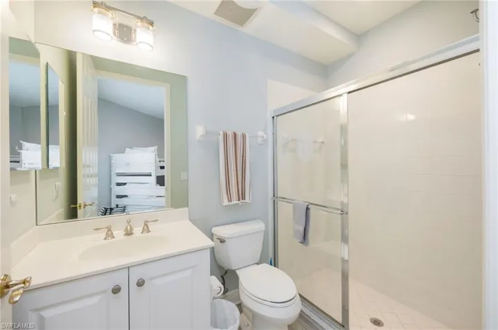 Full bath with a shower stall and vanity