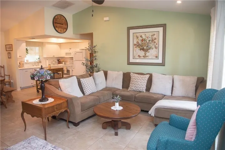 Tiled living room with lofted ceiling