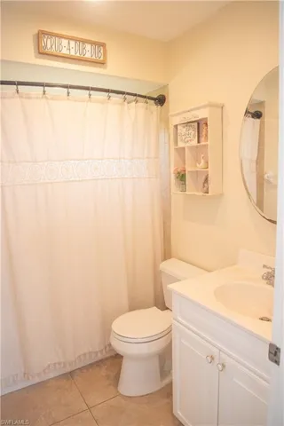 Bathroom featuring vanity, toilet, and tile patterned floors