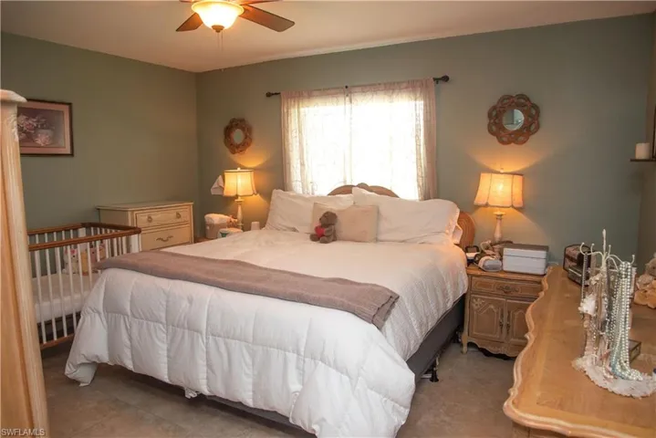 Bedroom featuring light tile patterned flooring and ceiling fan