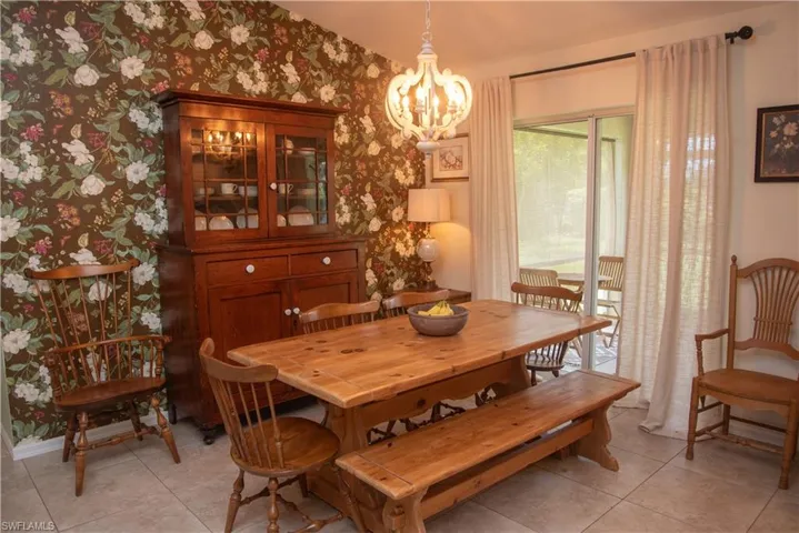 Dining room with a chandelier and light tile patterned floors