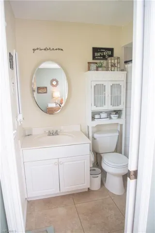 Bathroom featuring vanity, toilet, and tile patterned flooring