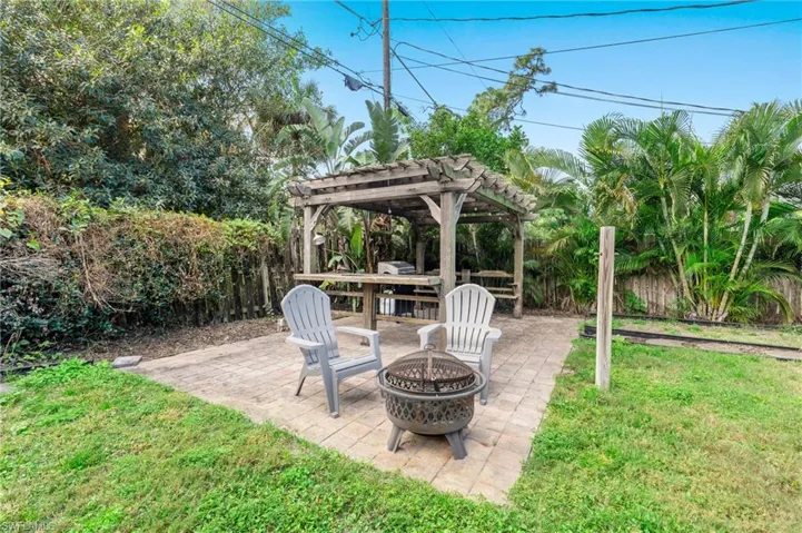 View of patio / terrace with a pergola and a fire pit