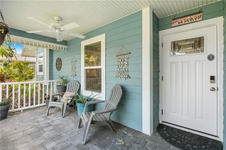 View of exterior entry featuring ceiling fan and covered porch