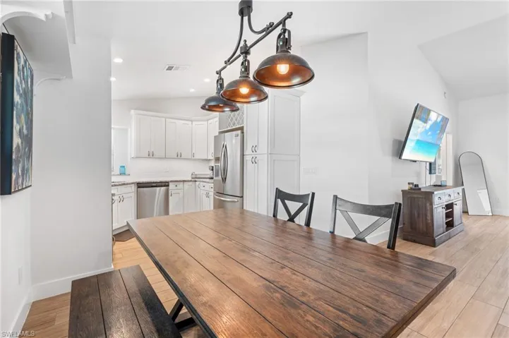 Dining space featuring vaulted ceiling
