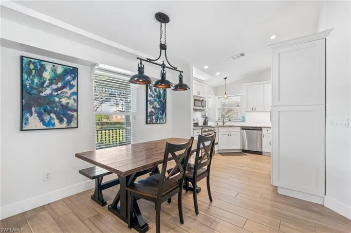 Dining area featuring sink and vaulted ceiling