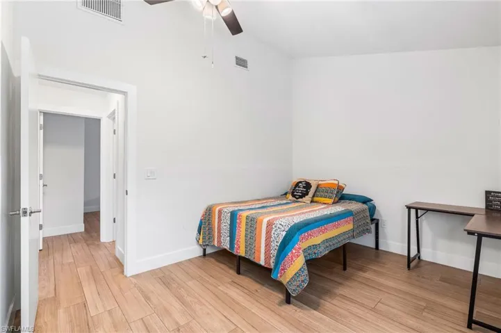 Bedroom with light hardwood / wood-style floors and ceiling fan