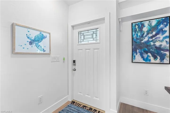 Entrance foyer with hardwood / wood-style flooring