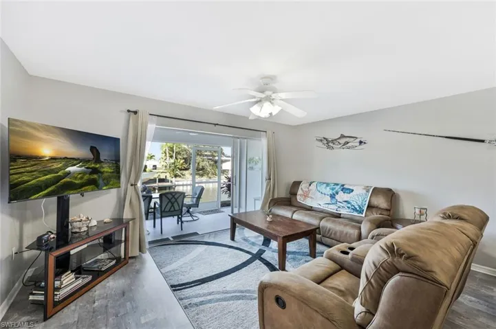 Living room with a ceiling fan and wood finished floors
