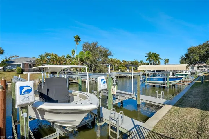 Dock featuring boat lift and a water view