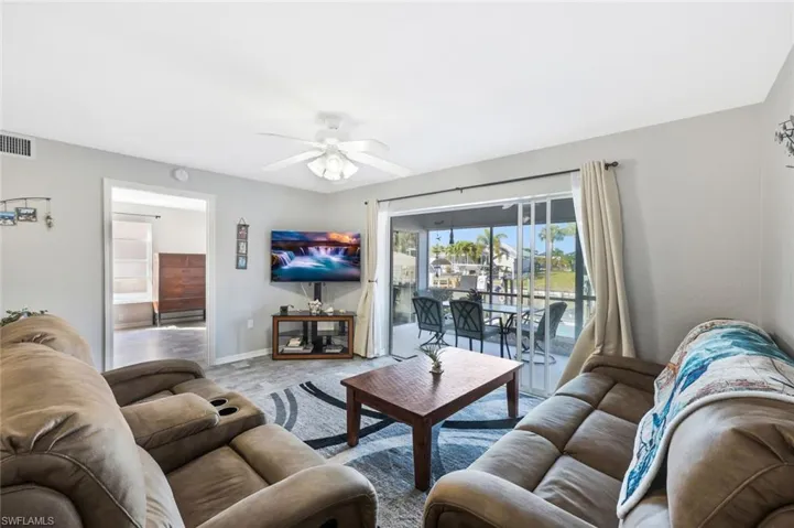 Living area featuring ceiling fan and baseboards