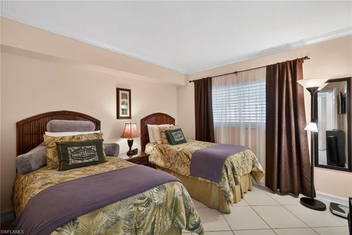 Bedroom featuring ornamental molding and light tile patterned floors