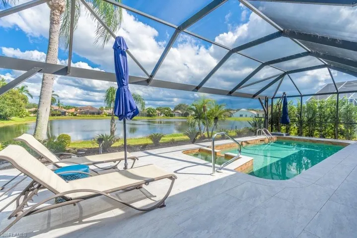 Chaise lounge chairs overlooking pool and lake view with windowpane screening.