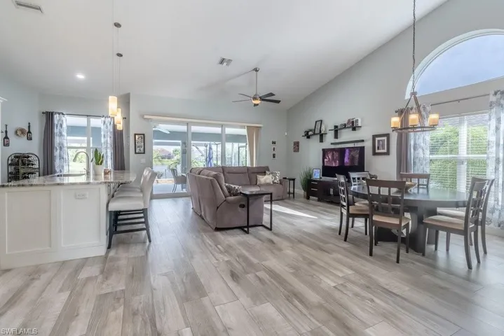 Great room with tile flooring and soaring ceilings.
