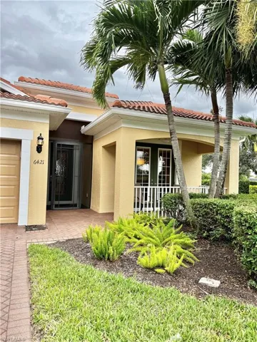 Doorway to property with stucco siding and a tiled roof