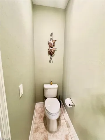 Bathroom featuring toilet and tile patterned floors