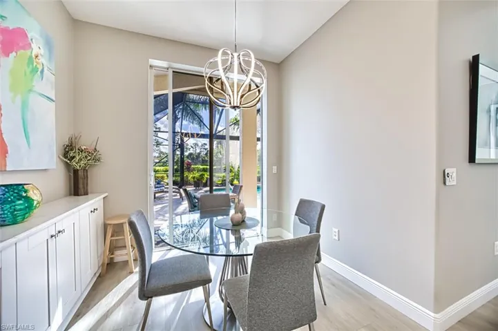 Dining area with a notable chandelier and light hardwood / wood-style floors