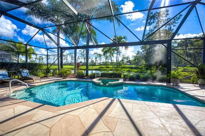 View of pool with a patio, an in ground hot tub, a lanai, and a water view