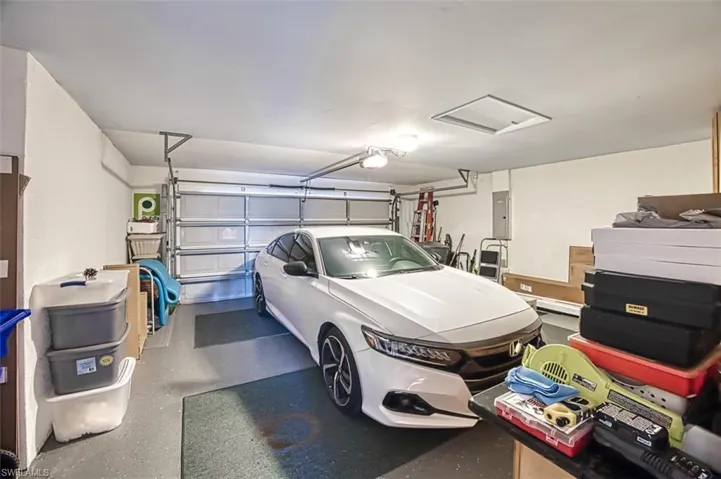 Garage with electric panel and a garage door opener