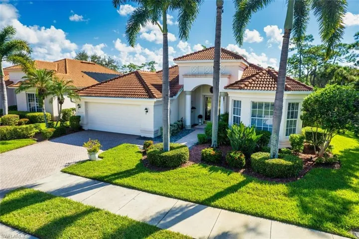Mediterranean / spanish-style house with a front yard and a garage