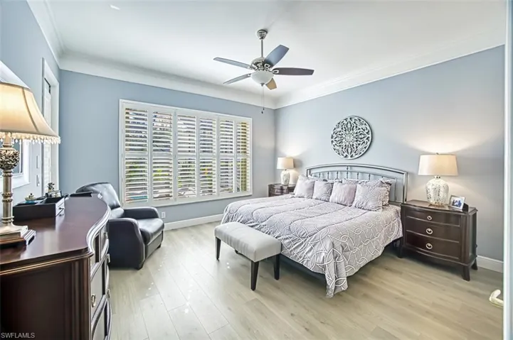 Bedroom featuring crown molding, ceiling fan, and light hardwood / wood-style flooring