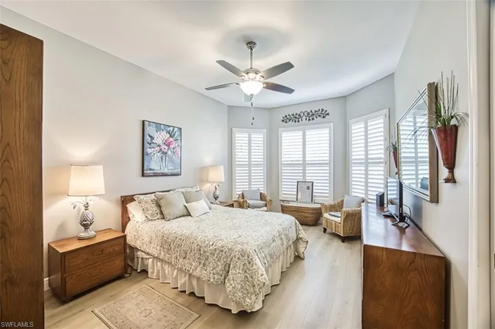 Bedroom featuring ceiling fan and light hardwood / wood-style flooring