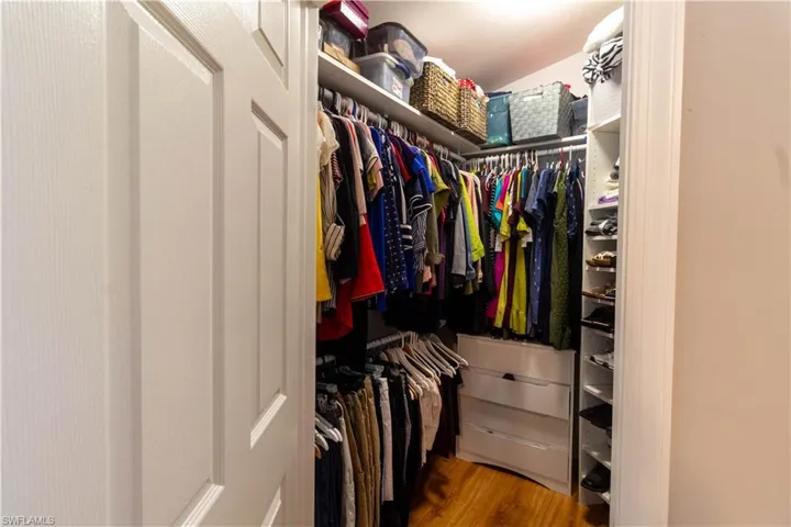 Spacious closet with wood finished floors