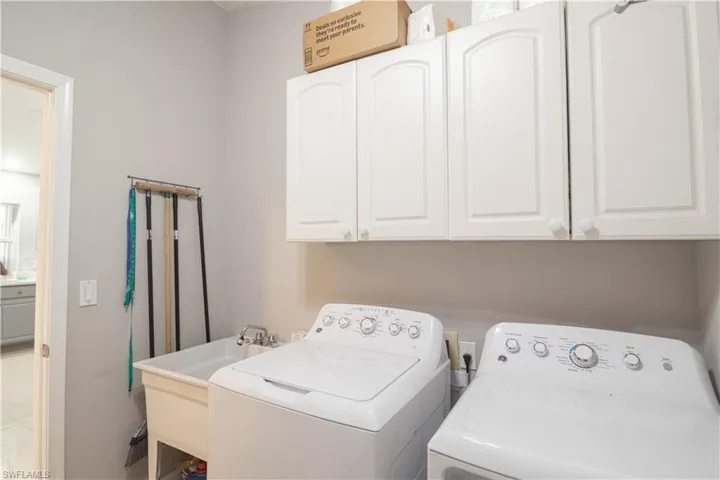 Laundry area with independent washer and dryer and cabinet space