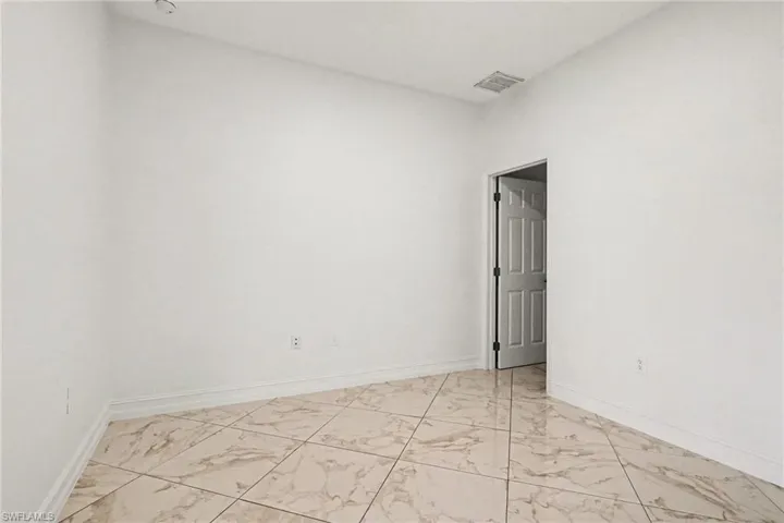 Empty room with light marble finish floors and baseboards
