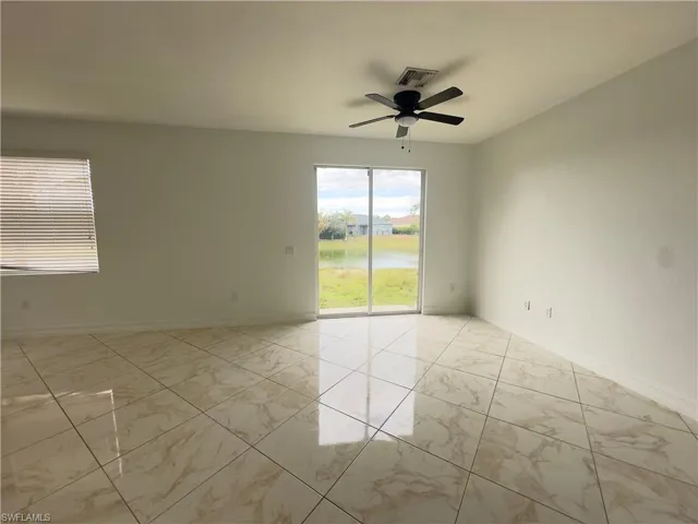 Kitchen featuring white cabinets, ceiling fan, stainless steel appliances, a peninsula, and a chandelier
