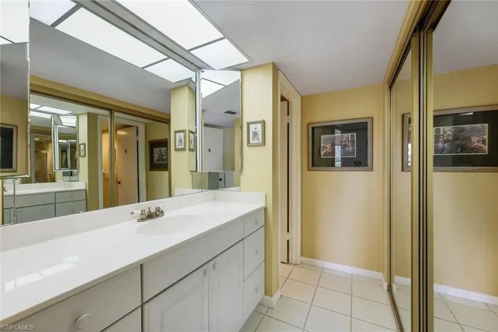 En suite primary bathroom offers dual sinks and a walk-in closet.