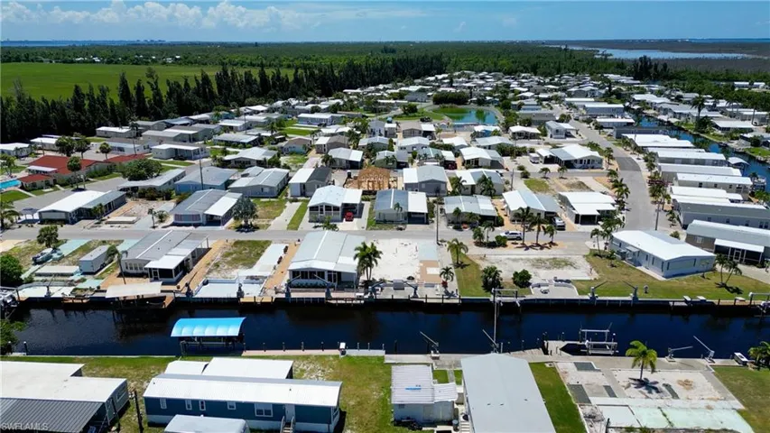 Aerial overview of property's location featuring a nearby body of water and nearby suburban area